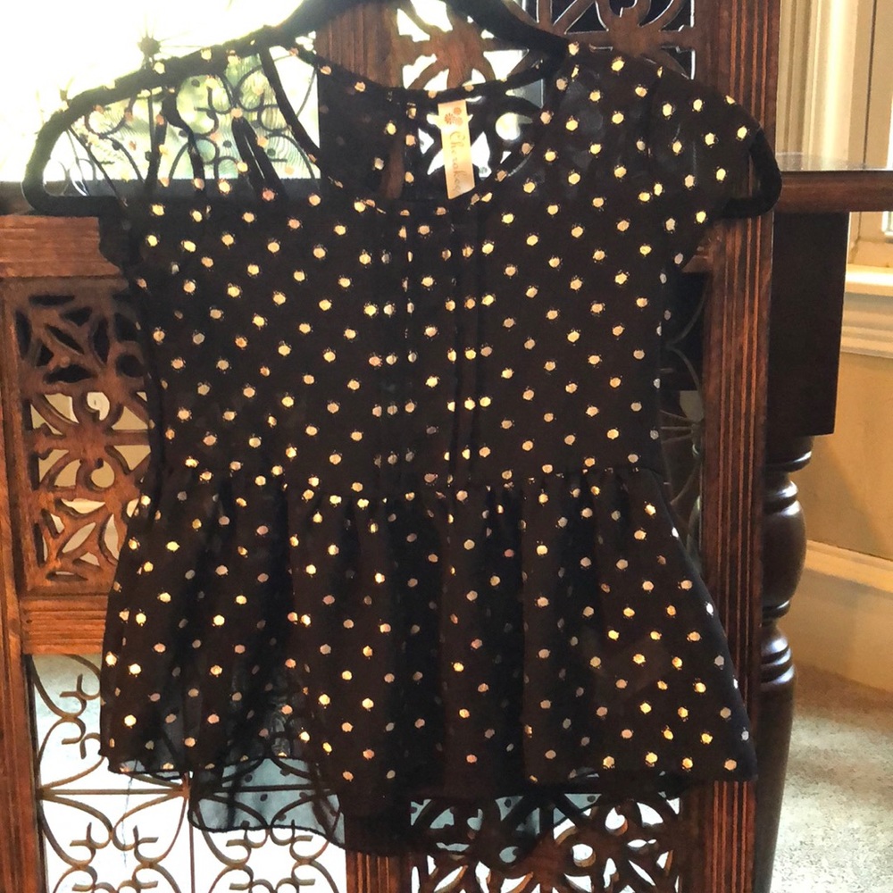 Girls black top with metallic dots.